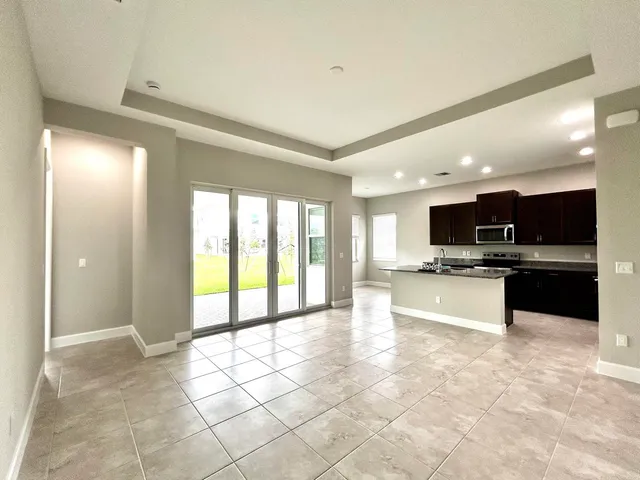 a large kitchen with a large counter top and stainless steel appliances