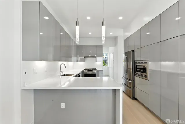 a kitchen with a stove and a refrigerator