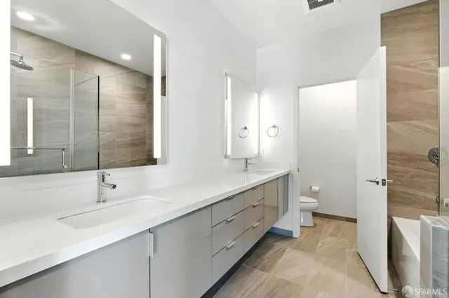 a bathroom with a sink toilet and a mirror