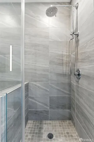 a bathroom with a bath tub with a shower