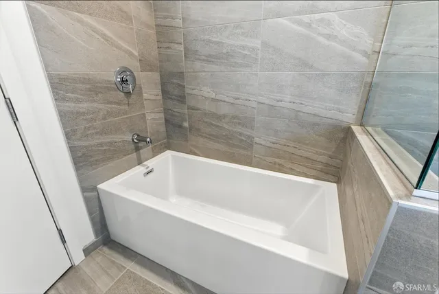 a bedroom with a bed and a desk