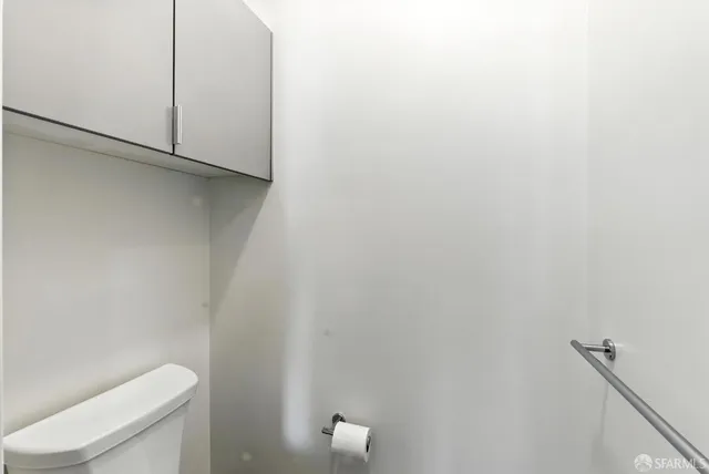 a bathroom with a sink toilet and a mirror
