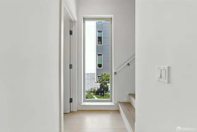 a front view of a building with a garden