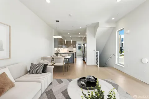 a kitchen with a sink cabinets and wooden floor