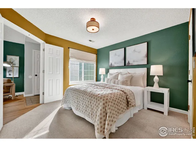 a bedroom with a bed and a night stand