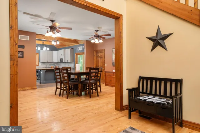 a kitchen with stainless steel appliances granite countertop a refrigerator a sink and white cabinets