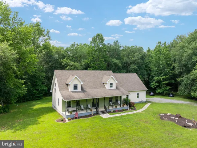 a aerial view of a house with swimming pool and yard