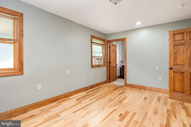 a view of walk in closet with empty room
