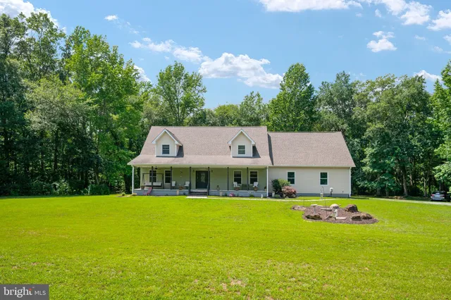 a view of a house with a yard patio and swimming pool