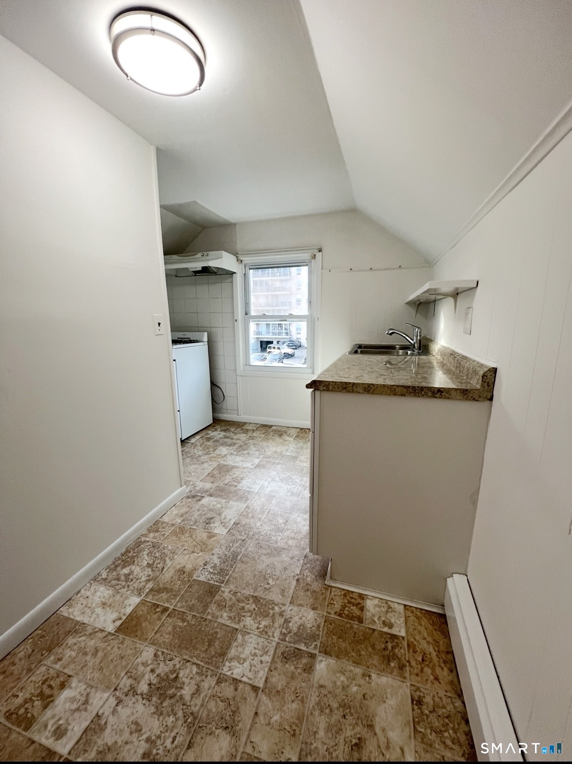 106 Lafayette Street, Unit 3 Stamford, CT 06902 - Photo 2 of 7 a room with granite countertop a sink and a stove