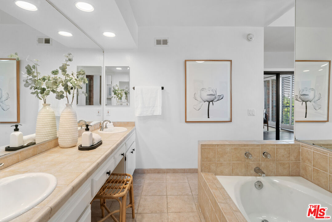 4421 Alla Road, Unit 3 Marina del Rey, CA 90292 - Photo 16 of 31 a bathroom with a granite countertop tub sink and mirror