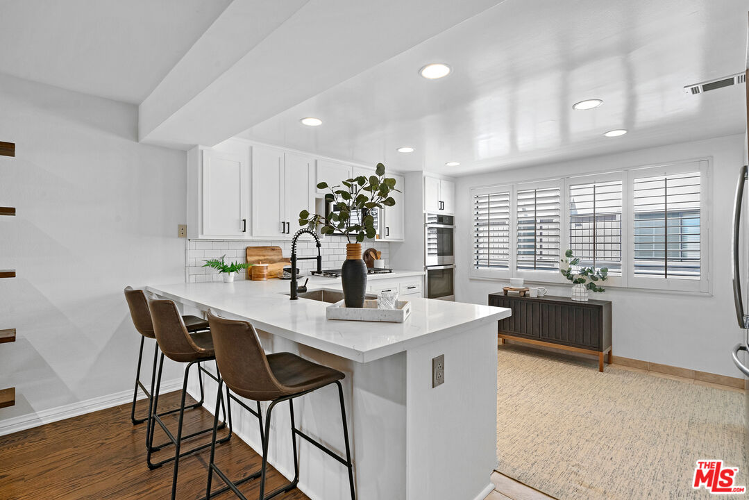 4421 Alla Road, Unit 3 Marina del Rey, CA 90292 - Photo 7 of 31 a dining hall with stainless steel appliances kitchen island granite countertop a dining table chairs and granite counter tops