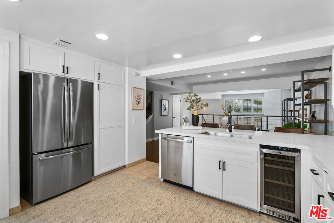 4421 Alla Road, Unit 3 Marina del Rey, CA 90292 - Photo 9 of 31 a kitchen with a refrigerator sink and cabinets