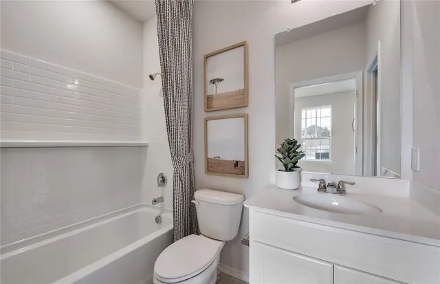 a bathroom with a granite countertop toilet a sink and a bathtub