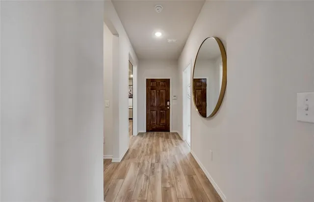 a view of a hallway with wooden floor