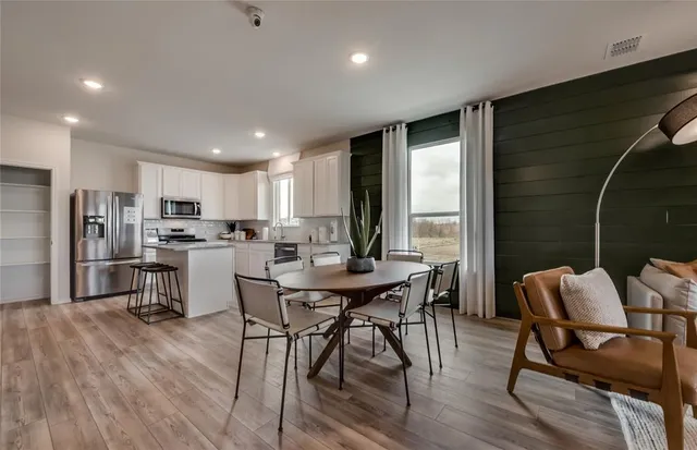 a view of a dining room with furniture and wooden floor