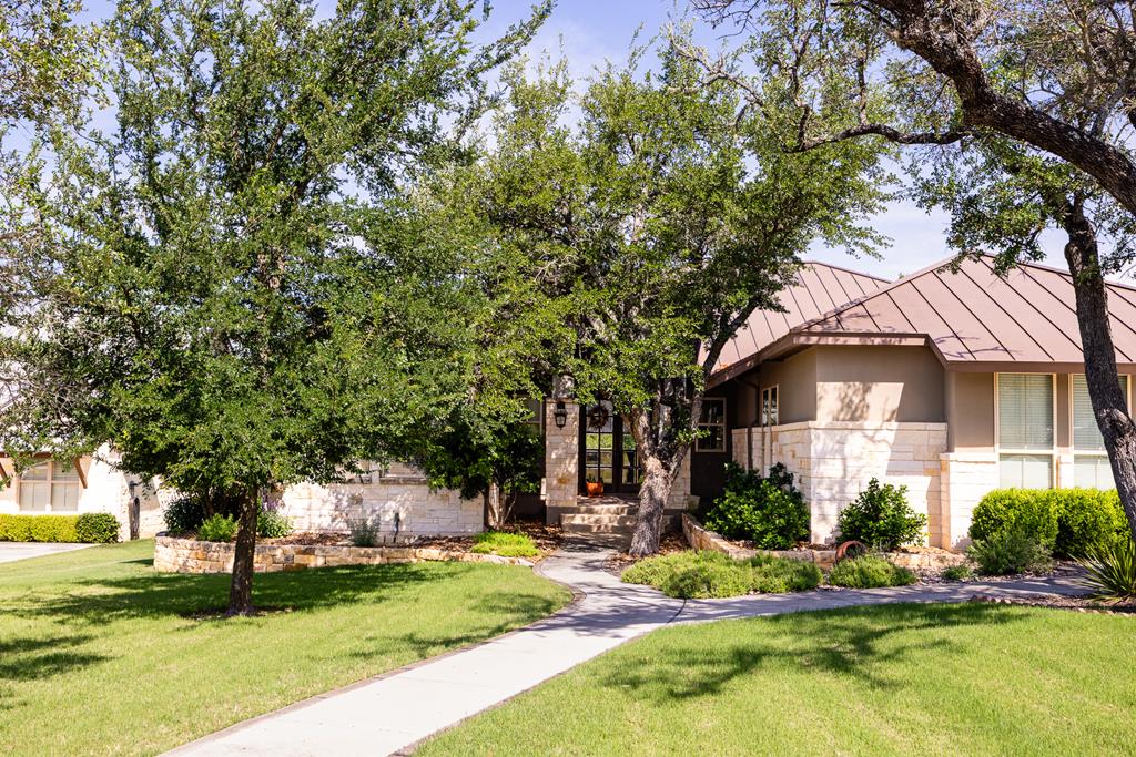 a front view of a house with a yard garage and outdoor seating