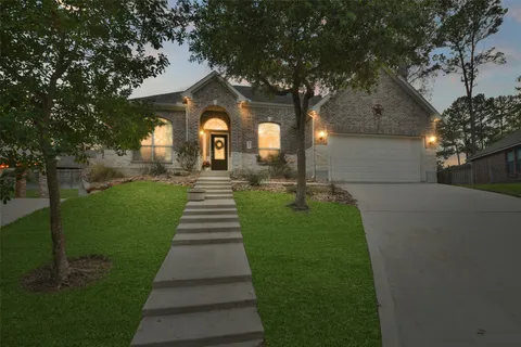 a view of a hallway to a livingroom with furniture and wooden floor