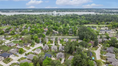 a view of a city with lush green forest
