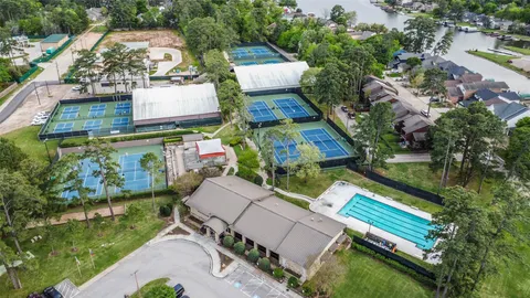 an aerial view of a house with a garden and lake view