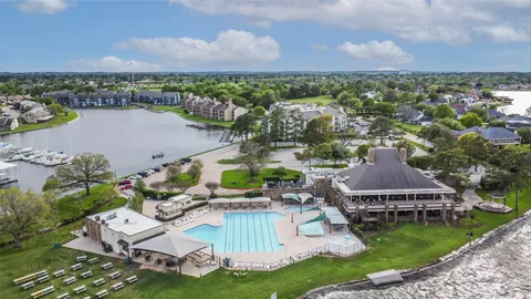 an aerial view of a house with a garden and lake view