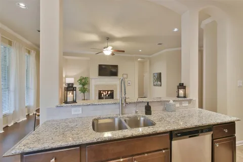 a kitchen with granite countertop a sink and cabinets