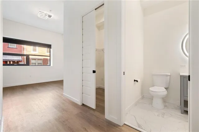 a bathroom with a toilet sink and a window