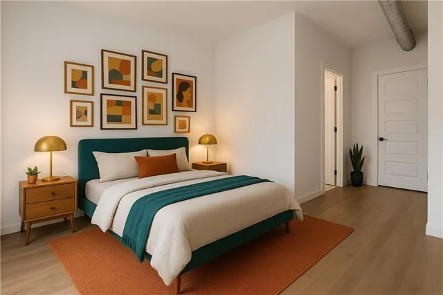 a bedroom with a bed and wooden floor