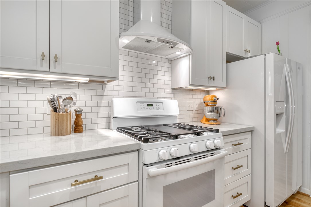 1524 Highway 159 Bellville, TX 77418 - Photo 12 of 33 a kitchen with granite countertop cabinets and white appliances