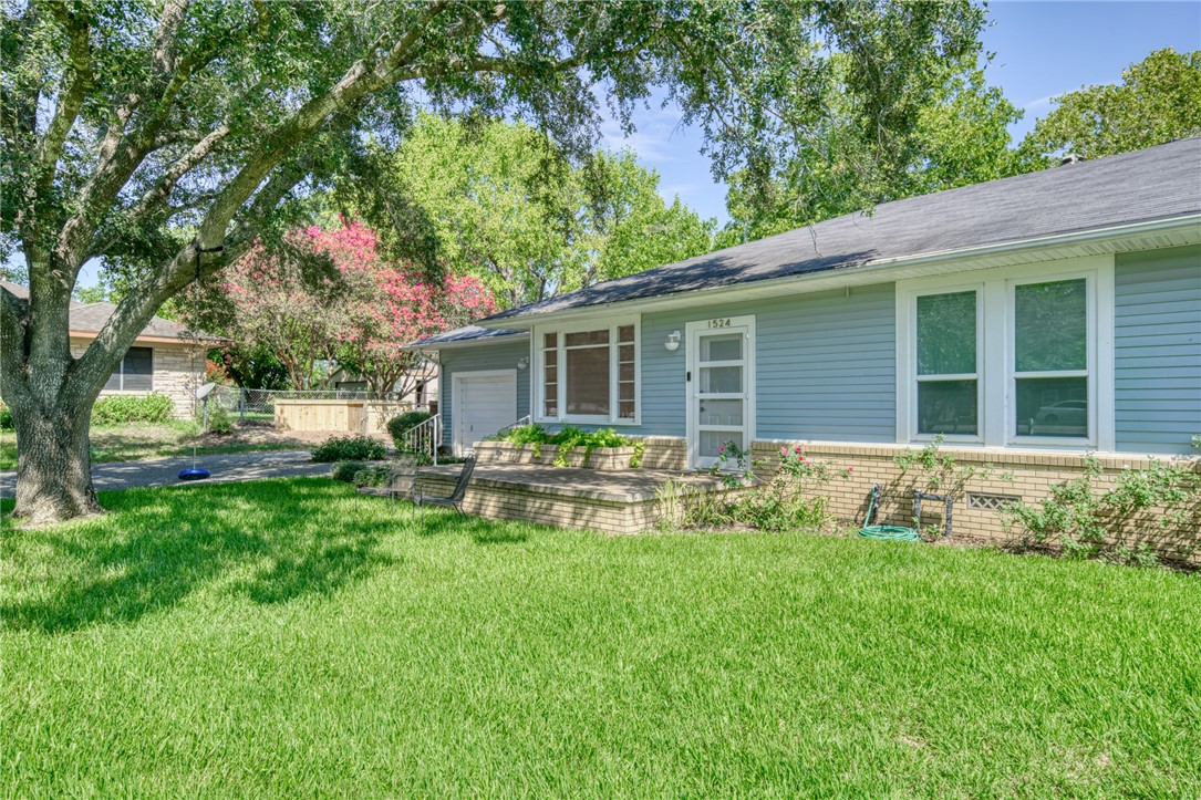 1524 Highway 159 Bellville, TX 77418 - Photo 33 of 33 a view of house with backyard sitting area and garden