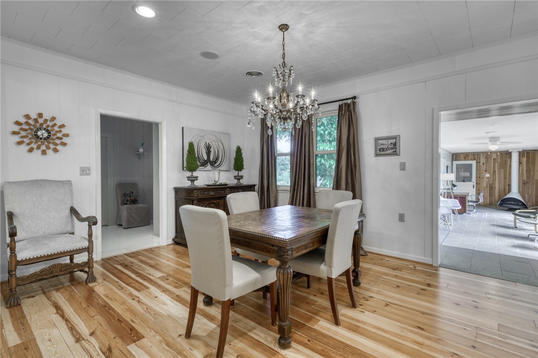 1524 Highway 159 Bellville, TX 77418 - Photo 8 of 33 a dining room with furniture wooden floor a chandelier and a rug