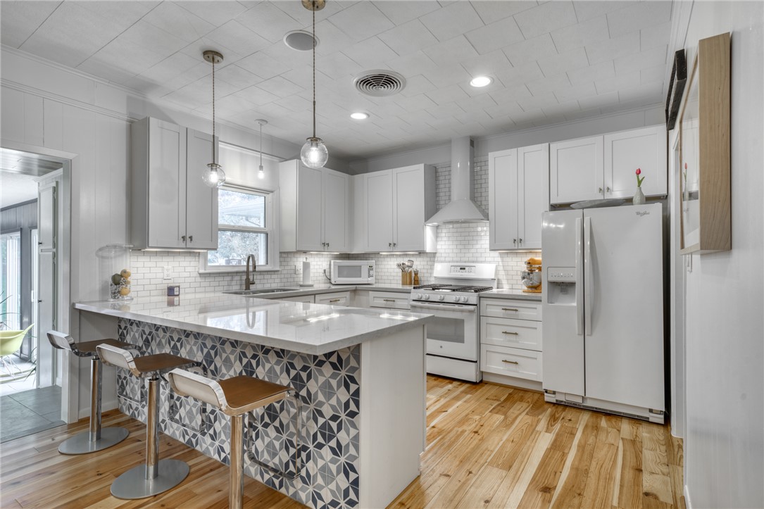 1524 Highway 159 Bellville, TX 77418 - Photo 9 of 33 a kitchen with kitchen island granite countertop a sink stove and refrigerator