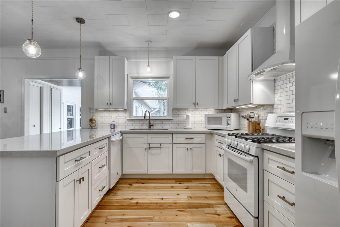 1524 Highway 159 Bellville, TX 77418 - Photo 10 of 33 a large kitchen with cabinets and white appliances