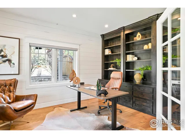 a living room with furniture a rug and windows