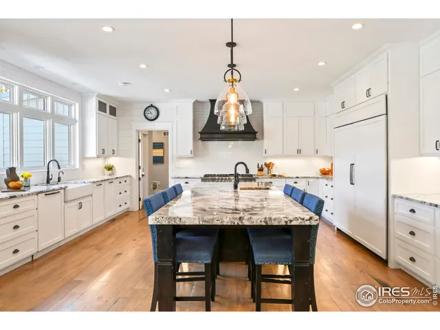a kitchen with granite countertop a sink appliances and cabinets