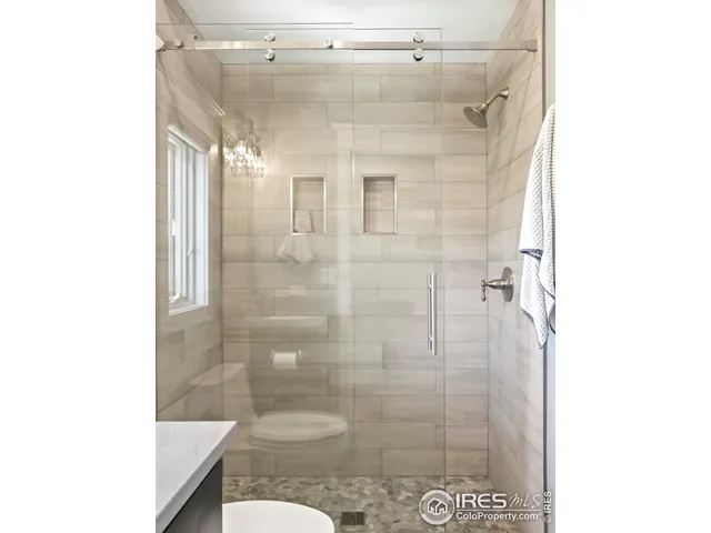 a bathroom with a shower and mirror