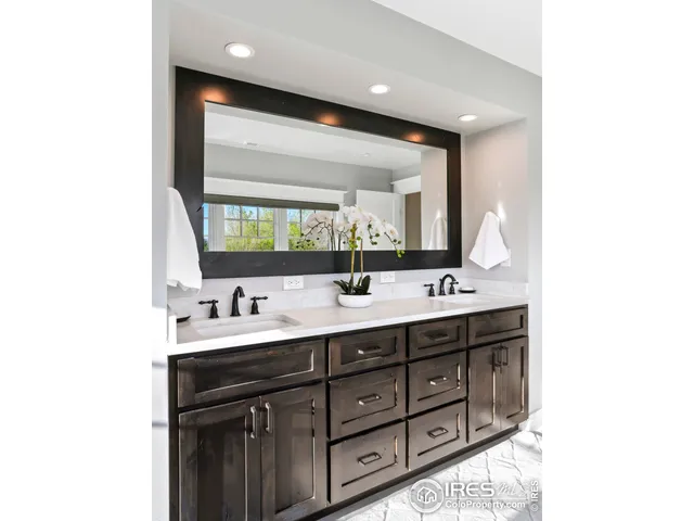 a bathroom with a double vanity sink and a mirror