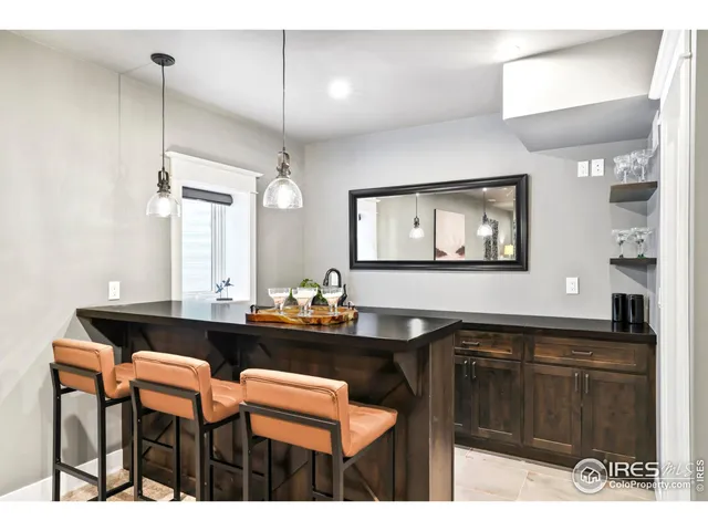 a kitchen with a sink cabinets and wooden floor