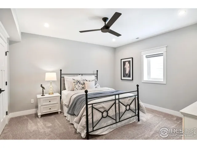 a bedroom with a bed a dresser and a window