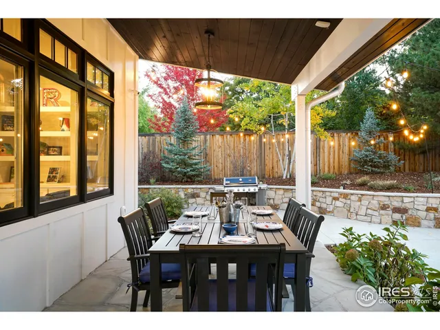 a view of an outdoor dining space with a table and chairs