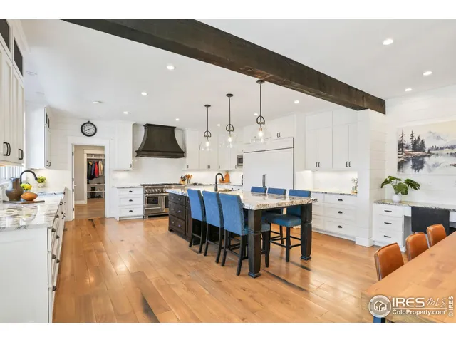 a living room with kitchen island furniture and a flat screen tv
