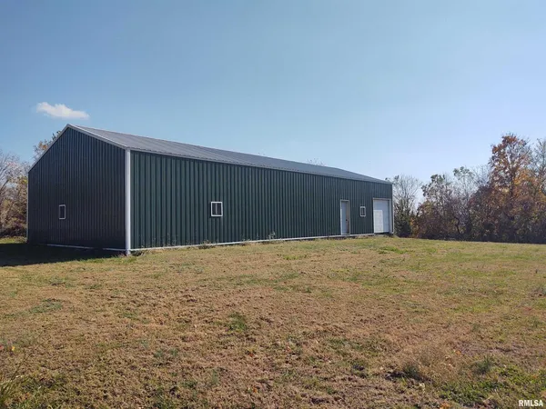 a view of an empty room with yard and garage