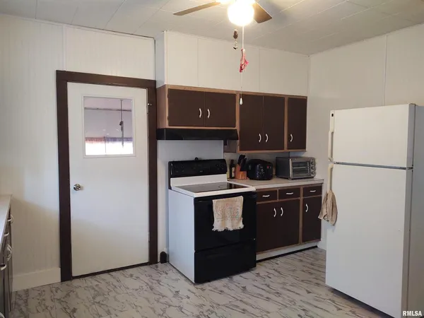 a kitchen with stainless steel appliances granite countertop a refrigerator and a stove