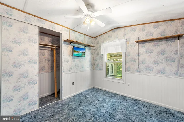 a bathroom with a granite countertop toilet sink and mirror