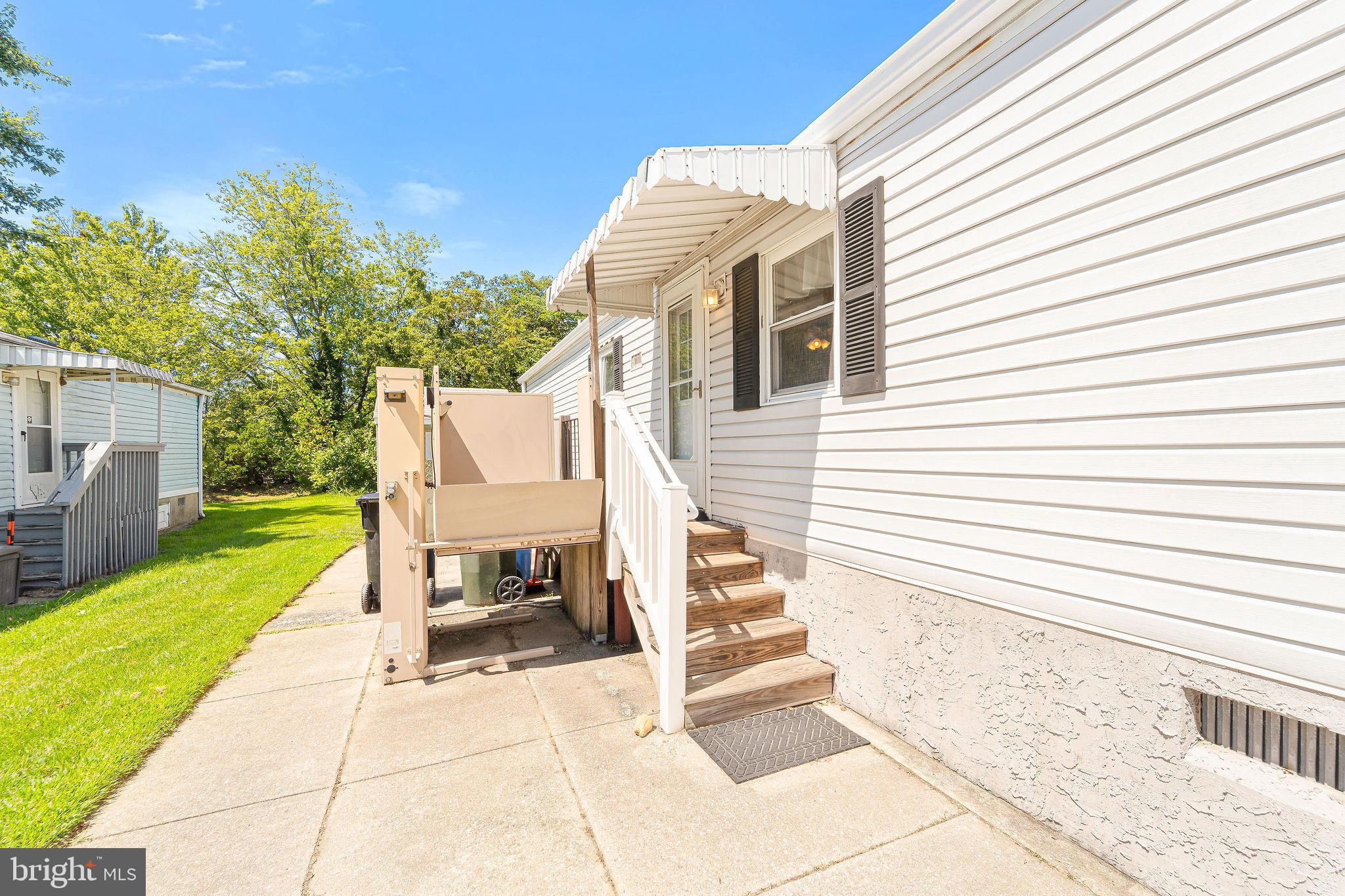 155 Whippoorwill Way Mantua, NJ 08051 - Photo 2 of 23 a view of a white house with a small yard and large trees