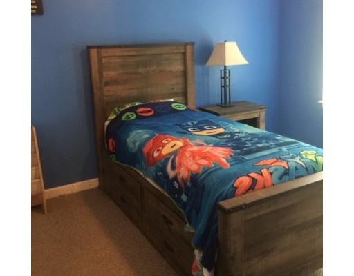 46 Fairview Park Road Sturbridge, MA 01566 - Photo 22 of 30 a bed sitting in a bedroom next to a lamp