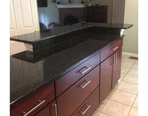 46 Fairview Park Road Sturbridge, MA 01566 - Photo 7 of 30 a kitchen with granite countertop a stove and a microwave