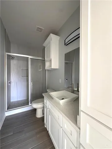 a spacious bathroom with a granite countertop sink toilet and shower