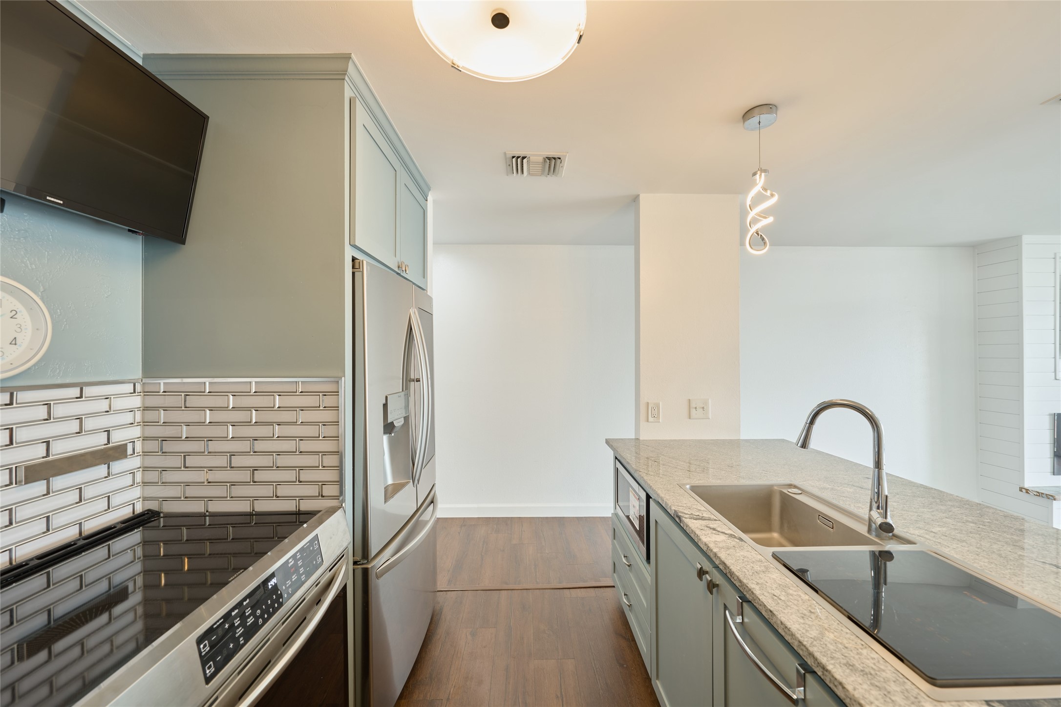 801 River Road, Unit E111 Montgomery, TX 77356 - Photo 11 of 24 a kitchen with stainless steel appliances granite countertop a sink and a stove