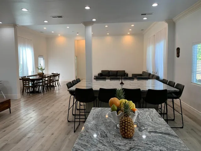 a view of a dining room with furniture and wooden floor